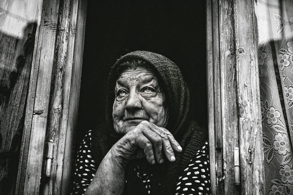 Elderly woman behind the counter in a small town